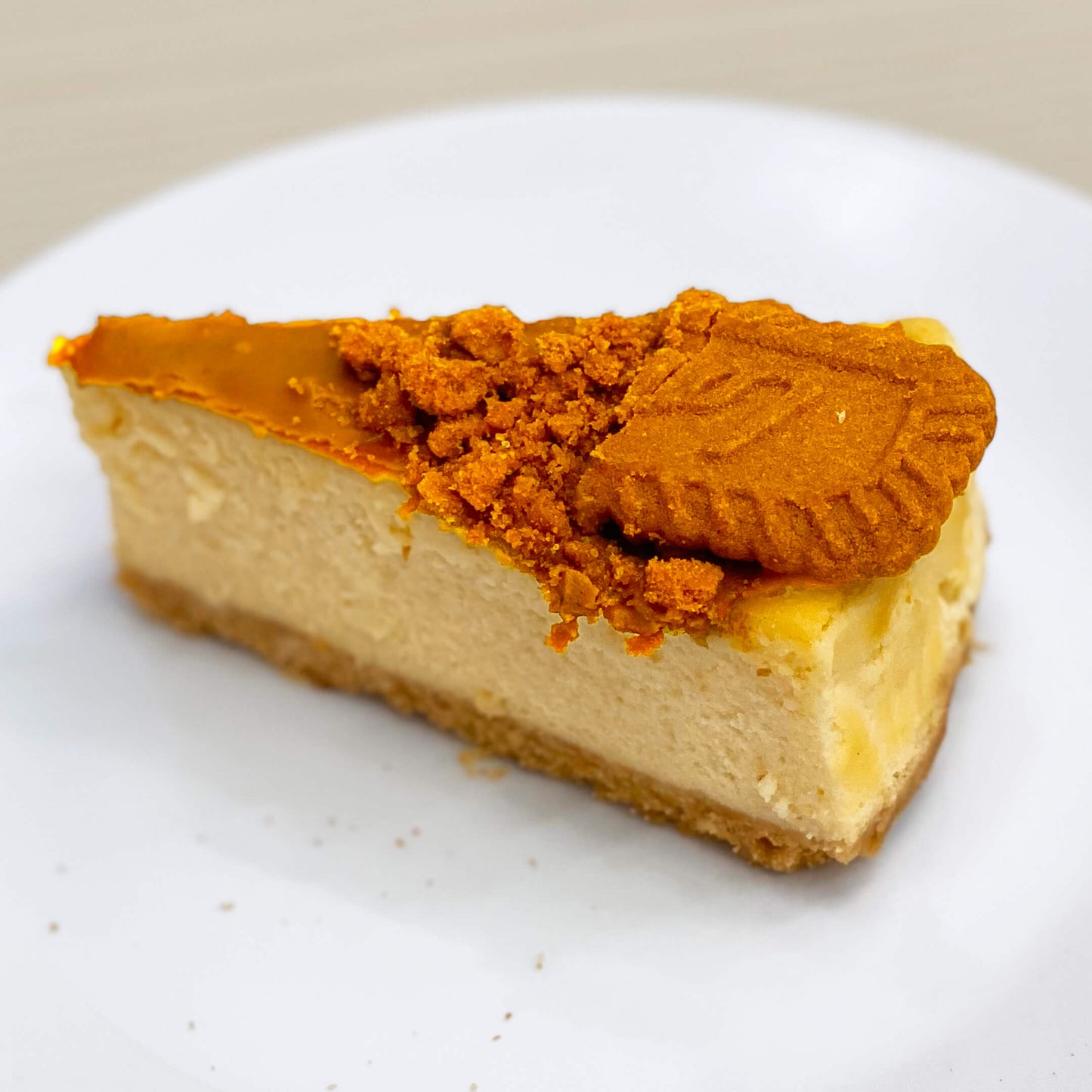 ชีสเค้กโลตัสบิสกอฟจากร้านเบเกอรี่ Yummy Yim ในพัทยา ชิ้นหนึ่งโรยด้วยเศษบิสกิตและตกแต่งด้วยบิสกิตโลตัสทั้งชิ้น